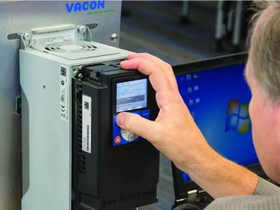 Technician programming a VACON variable frequency drive (VFD) via keypad